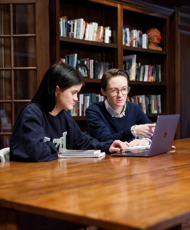 A student and faculty member review information together.